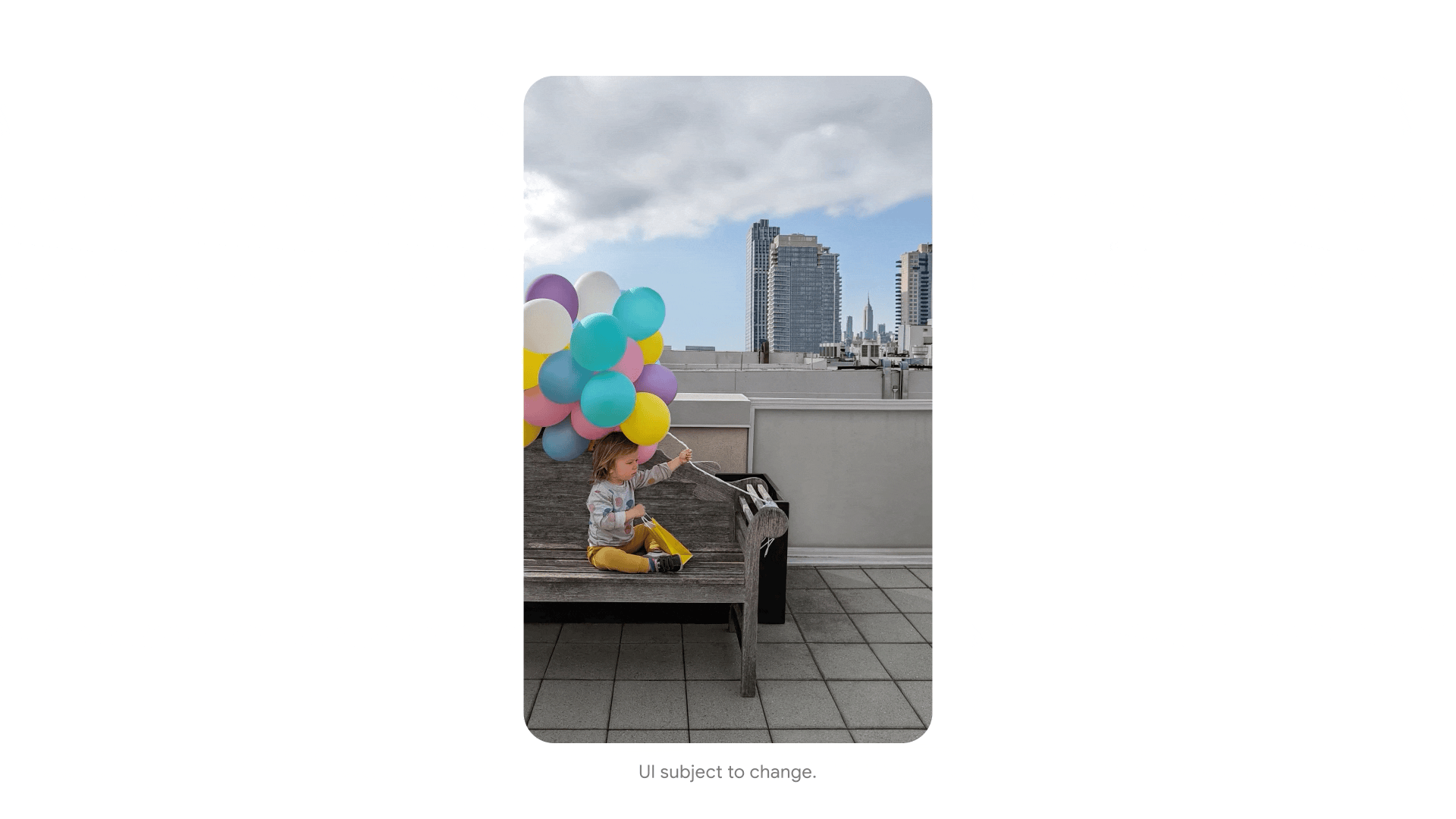An animation of a toddler-aged boy on a bench on a rooftop, holding a bunch of colorful balloons, with a city skyline in the background. In the shot on the right the boy is centered, you see more of the bench and balloons, and the sky is clearer.