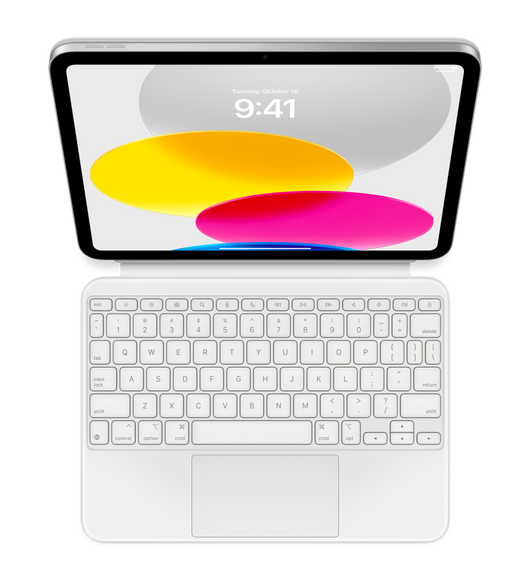 Näkymä ylhäältä päin pöydällä olevasta iPadista, johon on liitetty Magic Keyboard Folio. Näytöllä näkyy värikkäitä pyöreitä kuvioita.