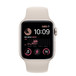 Starlight Aluminum Apple Watch with band, Digital Crown dial, side button, Starlight Sport Band showing inside of pin-and-tuck closure