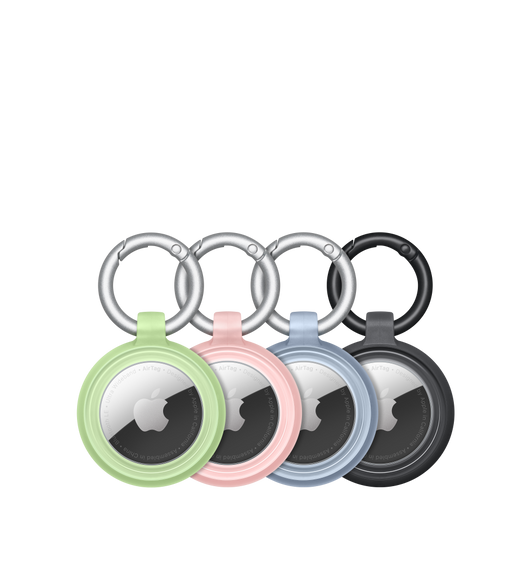 Des AirTag maintenus solidement dans quatre étuis Lumen Series d’Otterbox de couleur verte, rose, bleu et noire. Le logo Apple est visible au centre de chaque AirTag.