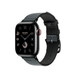 Image montrant le bracelet Toile H simple tour noir et denim (bleu), le cadran d’une Apple Watch et la Digital Crown.