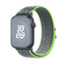 Bright Green and Blue Angled view of Nike Sport Loop, soft, breathable, and lightweight, featuring a hook-and-loop fastener for quick and easy adjustment.