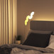 Nanoleaf Shapes Starter Kit, with the 9 LED light panels, mounted to a wall in a typical bedroom setting.