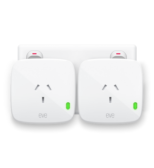 Two Eve Energys, Matter Version, plugged into a power socket with green LED power indicator showing it’s ON .