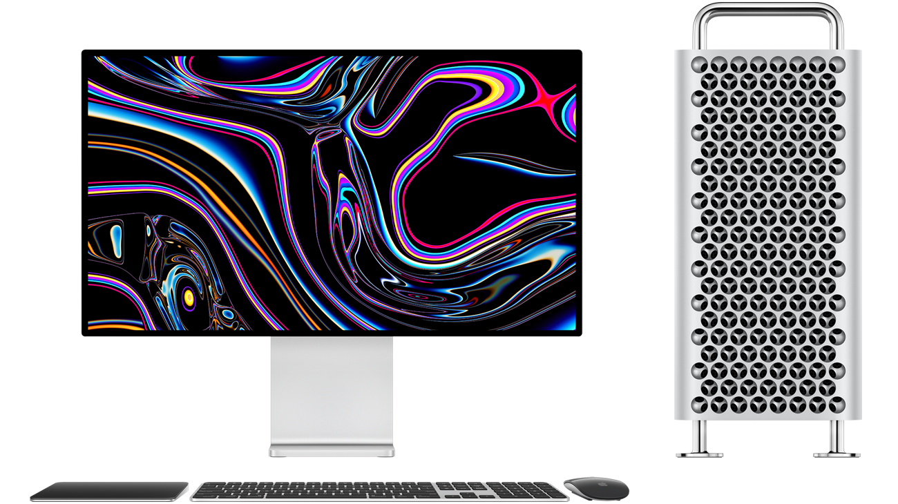 Mac Pro tower next to Pro Display XDR, Black and Silver Magic Trackpad, Black and Silver Magic Keyboard with Touch ID and Numeric Keypad, Black and Silver Magic Mouse