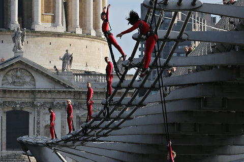 Dancers bungee jump off the Millennium Bridge as part of Elizabeth Streb's "One Extraordinary Day" in London.