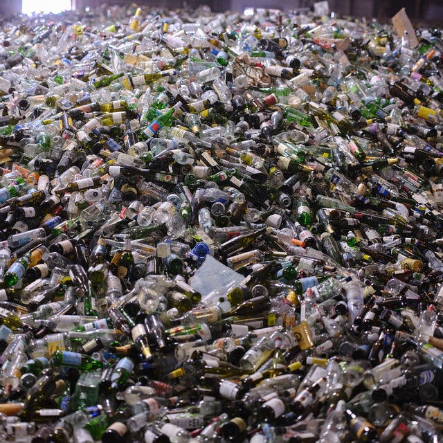 Thousands of bottles piled high inside the headquarters of Glass Half Full in New Orleans