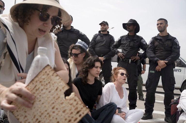 Israeli police officers with members of the protest group in southern Israel on Friday.