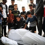 Mourning Palestinians killed overnight in an Israeli airstrike, in Rafah, southern Gaza Strip, on Saturday.