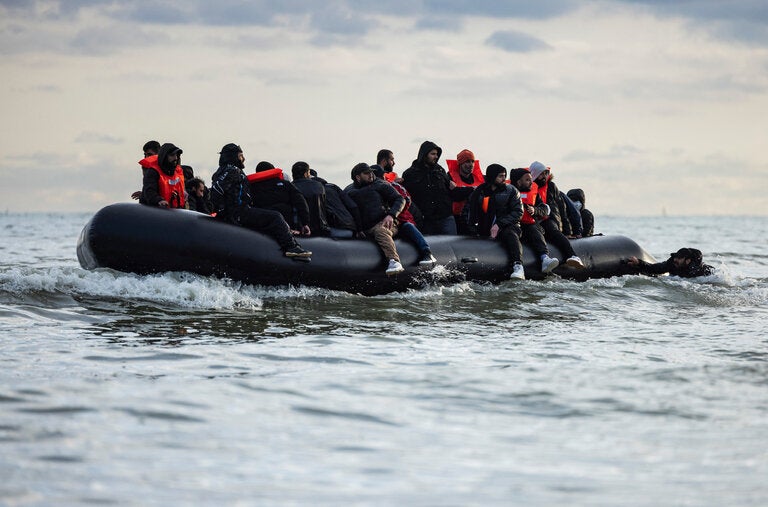 A smuggler’s boat prepared to cross the English Channel from a French beach on Friday.