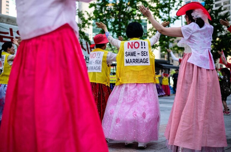 Anti-gay campaigners dancing on the sidelines of a Pride event during the Seoul Queer Culture Festival in July 2023.