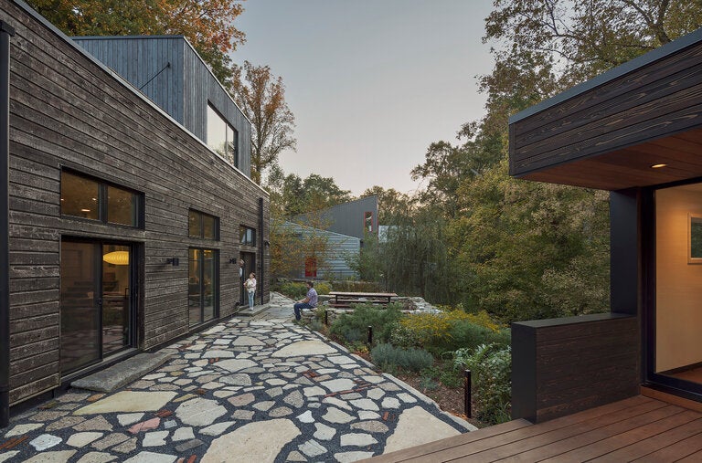 With concrete and other rubble found on site, Apiary Studio created a patio between a residence and writer’s cottage designed by the Philadelphia firm C2 Architecture.