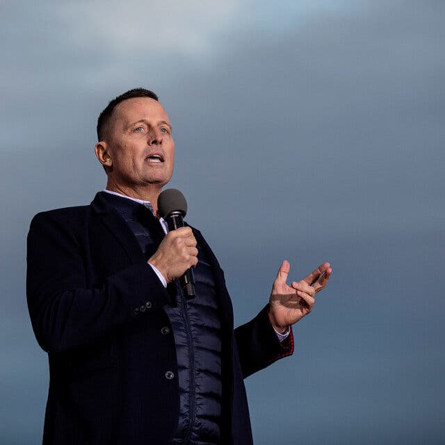 Richard Grenell, in a down jacket and over coat, speaking in Florence, Arizona.