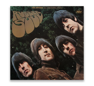 A record album cover with the words "Rubber Soul" printed in a stylized typeface above a photo of four long-haired young white men.