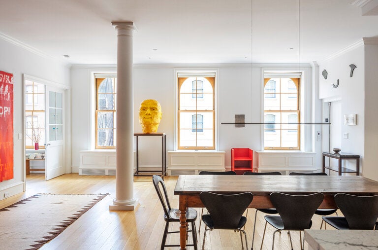 In the front of Peter Freeman and Lluïsa Sàrries Zgonc’s Manhattan loft, Thomas Schütte’s 2002 “Gelber Kopf” (“Yellow Head”), a 1984 Donald Judd chair in painted aluminum, a Hendl Helen Mirra weaving (2018) and three galvanized tin wall works by Richard Tuttle from “Letters (The Twenty-Six Series)” (1967).